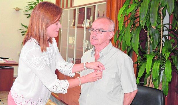 La alcaldesa le impone una insignia a Francisco Escarabajal.