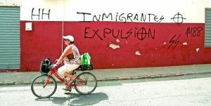 Una mujer pasa en bicicleta ante la fachada llena de pintadas de la mezquita de la calle Camino de La Aljorra. :: J. M. RODRÍGUEZ / AGM/