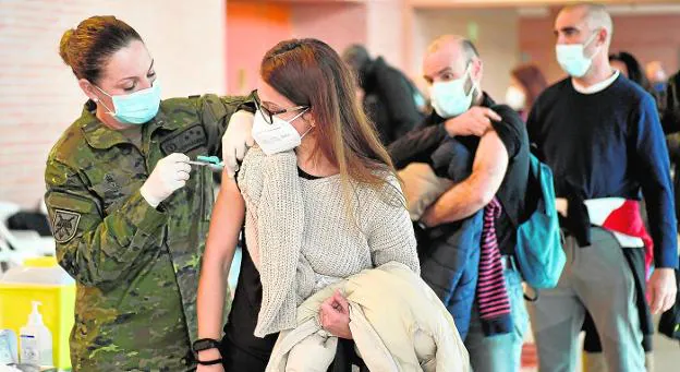 A professional from the Army gives the vaccine to a citizen yesterday at the Palacio de los Deportes in Murcia. 