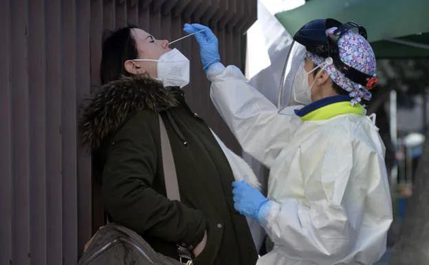 A medic performs an antigen test on a woman, in a file image.