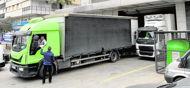 Some trucks carry out loading and unloading operations in a large warehouse in Murcia, during the day yesterday. 