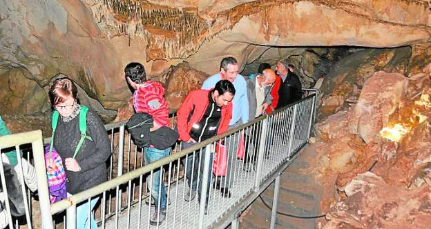 Tourists tour the Cueva del Puerto, on a guided tour. 