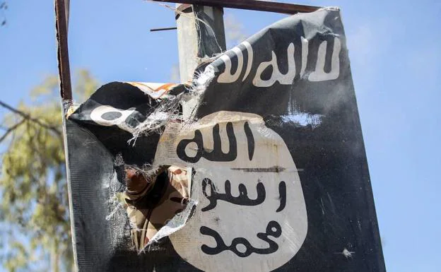 A soldier removes an Islamic State flag, in a file image