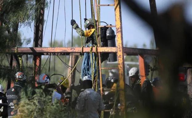 A member of the rescue team about to enter the cage to descend into the well