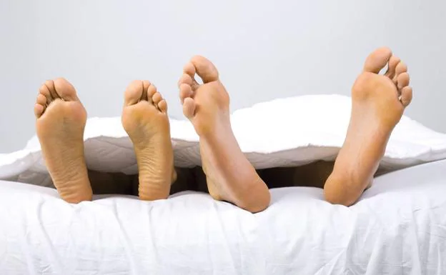 Two people lying on the bed.