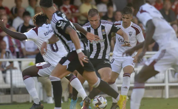 Ortuño comes out with the ball from a swarm of legs, against Albacete. 