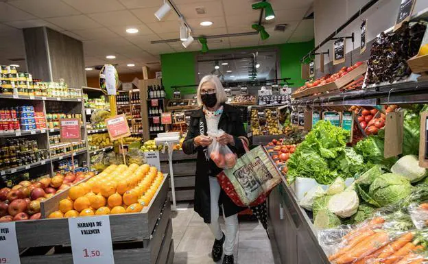 A woman does the shopping in a supermarket, in a file image- 