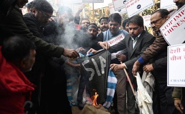 Traders burn Chinese-made clothing as part of a campaign to boycott Chinese products during a protest against the People's Liberation Army's alleged incursions into Indian territory, in New Delhi on December 21.  On video, images of the confrontation.