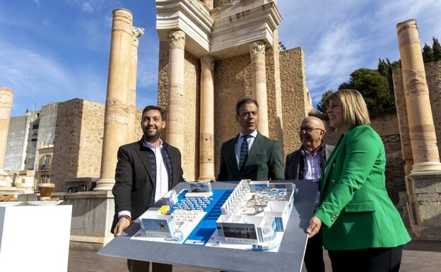 The director of Itrem, Ortuño, Padín and Arroyo, at the Roman Theater in Cartagena, hold the model of the Region's stand at Fitur. 